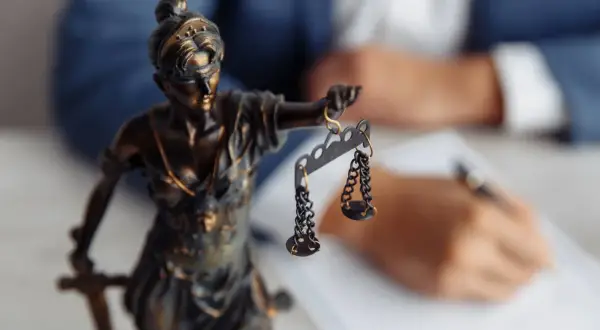 Figurka Temidy z wagą symbolizuje sprawiedliwość w procesie o stwierdzenie nabycia spadku.