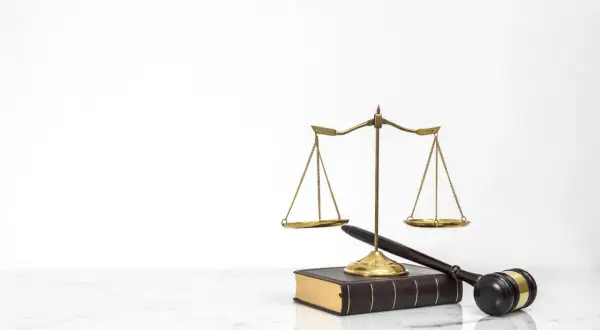 Waga sprawiedliwości, młotek sędziowski i księga prawa. Symbolizują sprawiedliwy proces, który może zadecydować o tym, kto zostanie jedynym spadkobiercą testamentowym.